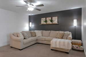 Living room with light carpet and ceiling fan