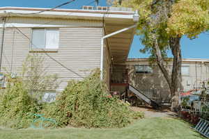 View of side of home featuring a lawn