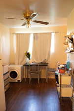 Interior space featuring dark wood-type flooring and ceiling fan