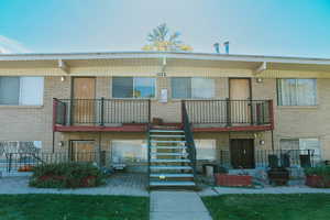 Back of property featuring a balcony and an outdoor fire pit