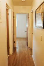 Corridor with light hardwood / wood-style flooring