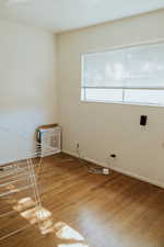 Spare room featuring wood-type flooring