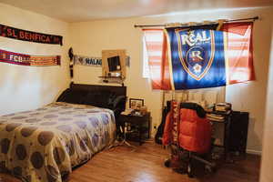 Bedroom featuring wood-type flooring