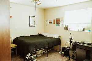 Bedroom featuring ceiling fan and carpet flooring