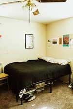 Carpeted bedroom featuring ceiling fan