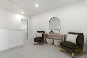 Sitting room featuring light colored carpet