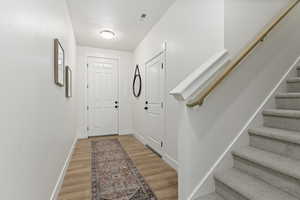 Doorway with hardwood / wood-style floors