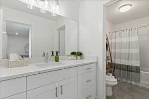 Full bathroom featuring vanity, toilet, and shower / tub combo