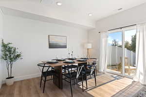 Dining space with hardwood / wood-style flooring