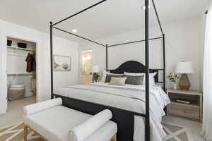 Bedroom featuring light colored carpet and a closet