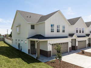 View of front of home with a garage and a front lawn