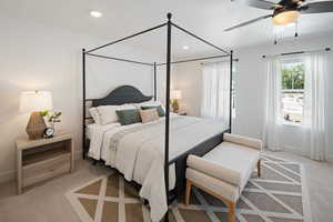 Carpeted bedroom featuring ceiling fan