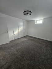 Unfurnished room with dark carpet