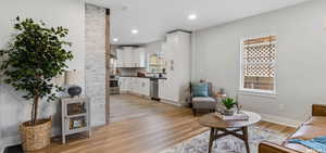 Living room featuring restored hardwood / wood-style floors