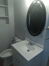 Half bathroom with toilet and vanity