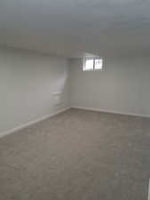 Basement with carpet and baseboards