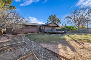 Back of property featuring a yard and a deck