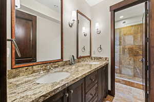 Bathroom with a shower with shower door and vanity