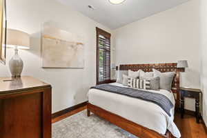 Bedroom with hardwood / wood-style flooring