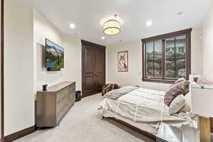 Bedroom featuring light colored carpet