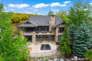 Rear view of property with a balcony and a patio area