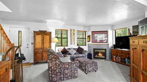 Living room with light colored carpet and a fireplace