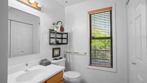 Bathroom with vanity, plenty of natural light, and toilet