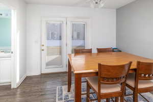 Dining area with sink and dark wood-type flooring