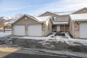 View of front facade with a mountain view and a garage