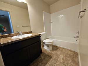 Full bathroom with vanity, tub / shower combination, and toilet