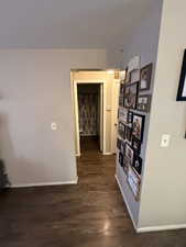 Corridor featuring dark hardwood / wood-style floors