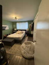 Bedroom featuring dark hardwood / wood-style flooring and a closet