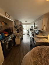 Dining area with dark hardwood / wood-style floors and washing machine and clothes dryer