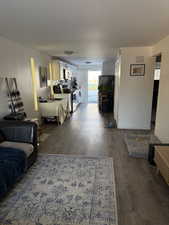 Living room with dark wood-type flooring