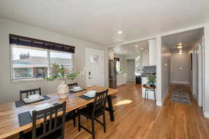 Dining area with light hardwood / wood-style flooring