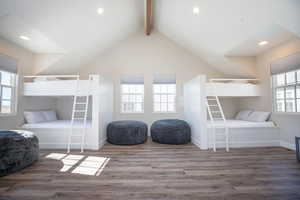 Bedroom featuring hardwood / wood-style flooring and lofted ceiling with beams