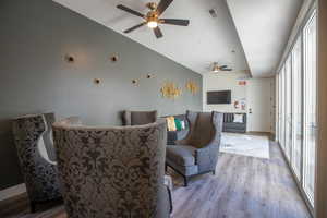 Living room featuring ceiling fan and light hardwood / wood-style floors