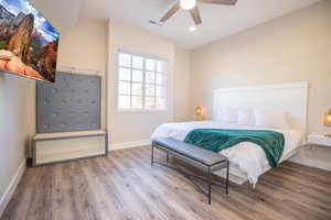 Bedroom with hardwood / wood-style flooring and ceiling fan