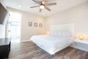 Bedroom with ceiling fan and light wood-type flooring