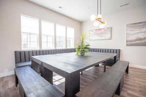 Dining space featuring hardwood / wood-style floors, a notable chandelier, and breakfast area