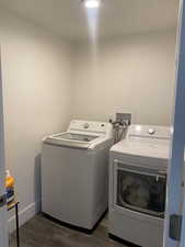 Laundry area featuring washer and dryer and dark hardwood / wood-style floors