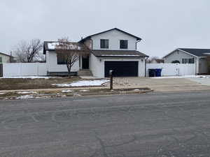 View of front of property featuring a garage