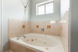 Bathroom featuring tiled tub