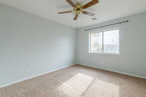 Unfurnished room featuring carpet flooring and ceiling fan