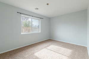 Unfurnished room with carpet