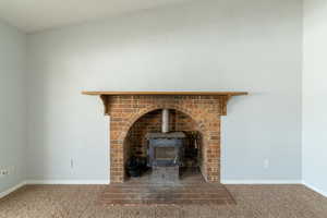 Details featuring carpet and a wood stove