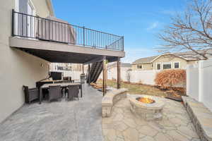 View of patio with a fire pit