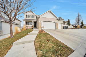 View of front of home featuring a garage, a front yard, and a porch