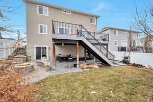 Back of house with cooling unit, a fire pit, a lawn, and a patio