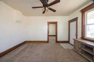 Carpeted empty room featuring ceiling fan